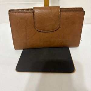brown leather wallet with an expandable double-snap closure.